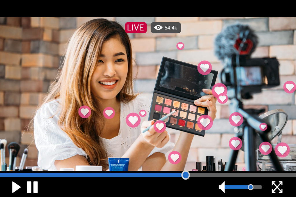 Woman-does-makeup-while-recording-live-stream-with-video-player-interface
