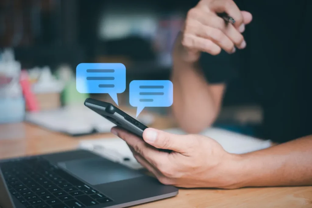 on phone with two chat bubbles popping out