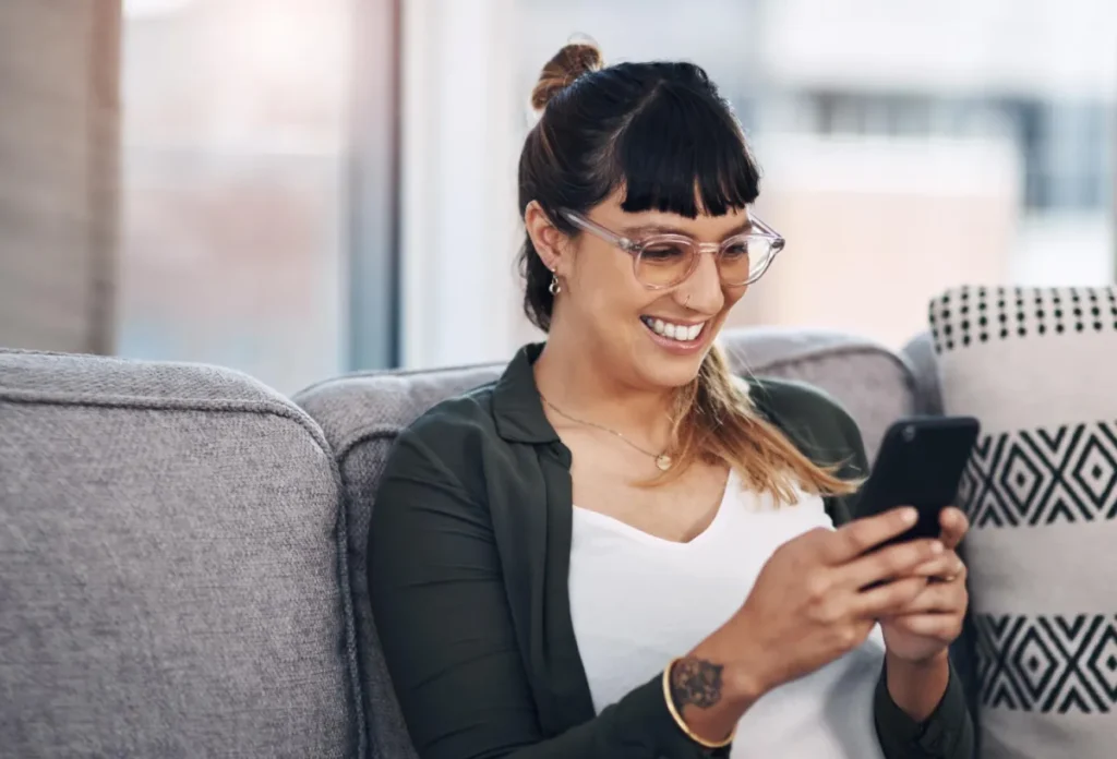 girl on phone with glasses and tatoos